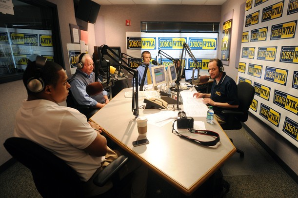 WTKA 1050 radio host Ira Weintraub (right) chats with former Michigan football player Mike Hart and former assistant coach Jerry Hanlon during a fundraiser for Mott Children's Hospital at the station on Friday. Melanie Maxwell I AnnArbor.com